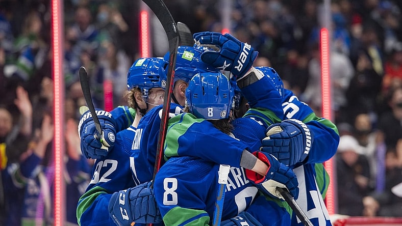 Dec 14, 2021; Vancouver, British Columbia, CAN; Vancouver Canucks forward Elias Pettersson (40) and forward Conor Garland (8) celebrate Pettersson s goal against the Columbus Blue Jackets in the third period at Rogers Arena. Vancouver Won 4-3. Mandatory Credit: Bob Frid-USA TODAY Sports