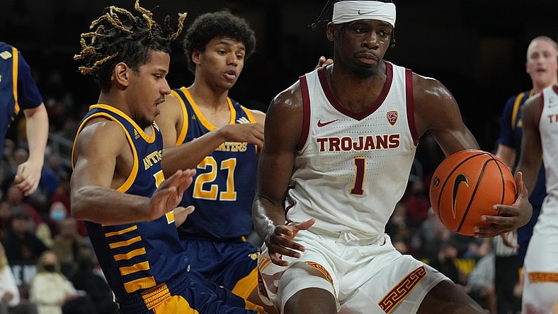 Dec 15, 2021; Los Angeles, California, USA; Southern California Trojans forward Chevez Goodwin (1) is defended by UC Irvine Anteaters guard DJ Davis (22) and guard Langston Redfield (21) in the second half at Galen Center. USC defeated UCI 66-61. Mandatory Credit: Kirby Lee-USA TODAY Sports