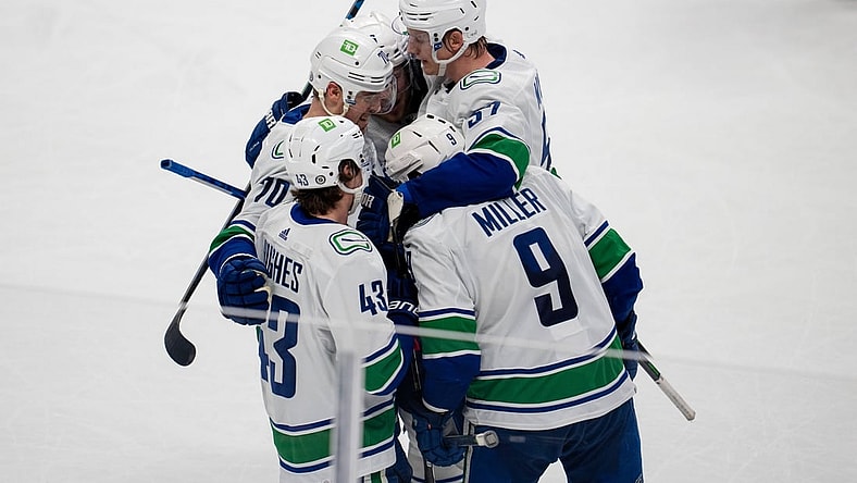 Dec 16, 2021; San Jose, California, USA; Vancouver Canucks center J.T. Miller (9), defenseman Quinn Hughes (43), defenseman Tyler Myers (57) and left wing Tanner Pearson (70) celebrate after a goal during the third period against the San Jose Sharksat SAP Center at San Jose. Mandatory Credit: Neville E. Guard-USA TODAY Sports