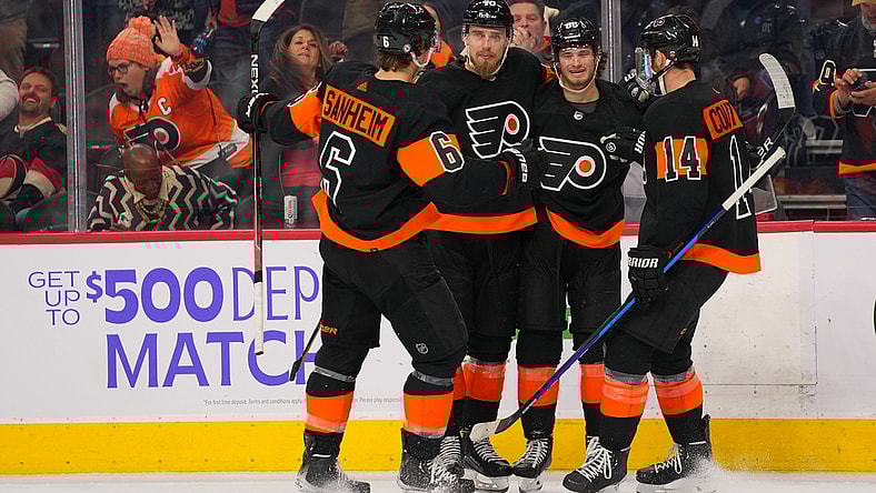 Dec 18, 2021; Philadelphia, Pennsylvania, USA; Philadelphia Flyers left wing Joel Farabee (86) celebrates with defenseman Travis Sanheim (6) and defenseman Rasmus Ristolainen (70) and center Sean Couturier (14) after scoring a goal against the Ottawa Senators in the third period at the Wells Fargo Center. Mandatory Credit: Mitchell Leff-USA TODAY Sports