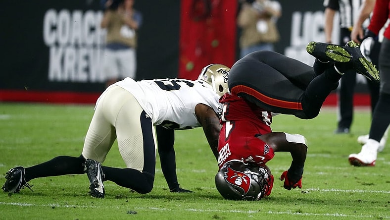 Dec 19, 2021; Tampa, Florida, USA; Tampa Bay Buccaneers wide receiver Chris Godwin (14) falls on his head after he catches the ball against the New Orleans Saints during the first half at Raymond James Stadium. Mandatory Credit: Kim Klement-USA TODAY Sports