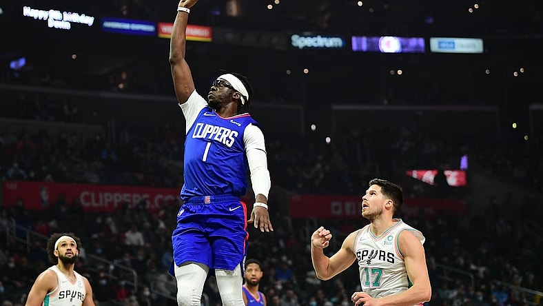 Dec 20, 2021; Los Angeles, California, USA; Los Angeles Clippers guard Reggie Jackson (1) shoots ahead of San Antonio Spurs forward Doug McDermott (17) during the first half at Staples Center. Mandatory Credit: Gary A. Vasquez-USA TODAY Sports