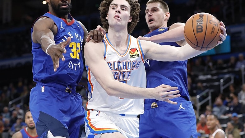 Dec 22, 2021; Oklahoma City, Oklahoma, USA; Oklahoma City Thunder guard Josh Giddey (3) passes the ball around Denver Nuggets forward Jeff Green (32) during the second half at Paycom Center. Oklahoma City won 108-94. Mandatory Credit: Alonzo Adams-USA TODAY Sports