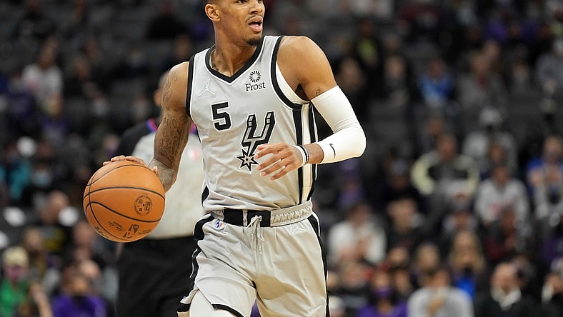 Dec 19, 2021; Sacramento, California, USA; San Antonio Spurs guard Dejounte Murray (5) dribbles during the second quarter against the Sacramento Kings at Golden 1 Center. Mandatory Credit: Darren Yamashita-USA TODAY Sports