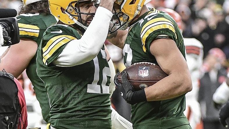 Dec 25, 2021; Green Bay, Wisconsin, USA; Green Bay Packers quarterback Aaron Rodgers (12) celebrates with wide receiver Allen Lazard (13) after setting the franchise record for most passing TDs in the first quarter during the game against the Cleveland Browns at Lambeau Field. Mandatory Credit: Benny Sieu-USA TODAY Sports