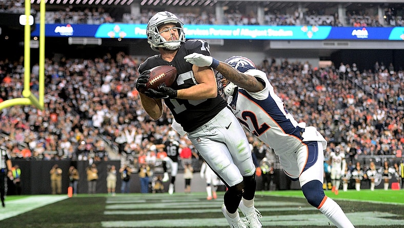 Dec 26, 2021; Paradise, Nevada, USA; Las Vegas Raiders wide receiver Hunter Renfrow (13) makes a touchdown catch against Denver Broncos safety Kareem Jackson (22) during the first half at Allegiant Stadium. Mandatory Credit: Joe Camporeale-USA TODAY Sports