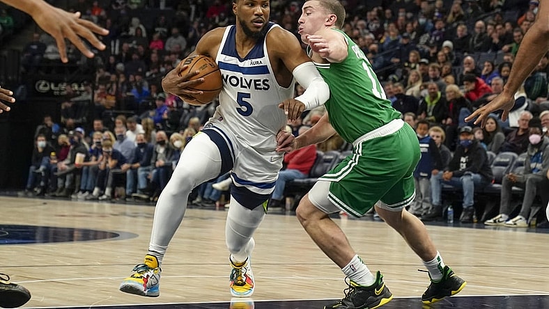 Dec 27, 2021; Minneapolis, Minnesota, USA; Minnesota Timberwolves guard Malik Beasley (5) drives to the basket as Boston Celtics guard Payton Pritchard (11) defends during the second quarter at Target Center. Mandatory Credit: Nick Wosika-USA TODAY Sports