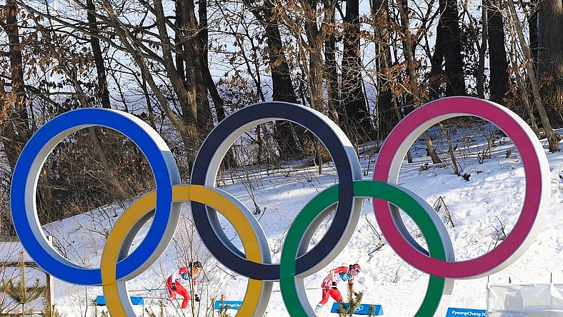 Feb 25, 2018; Pyeongchang, South Korea; Justyna Kowalczyk (POL) and Masako Ishida (JPN) ski past the Olympic rings in the women's 30km classic style cross country event during the Pyeongchang 2018 Olympic Winter Games at Alpensia Cross-Country Centre. Mandatory Credit: Kyle Terada-USA TODAY Sports