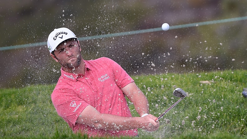 Jan 31, 2021; San Diego, California, USA; Jon Rahm plays a shot from a bunker on the 11th hole during the final round of the Farmers Insurance Open golf tournament at Torrey Pines Municipal Golf Course - South Course. Mandatory Credit: Orlando Ramirez-USA TODAY Sports