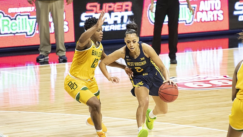 Mar 14, 2021; Kansas City, Missouri, USA; West Virginia Mountaineers guard Kysre Gondrezick (2) dribbles by Baylor Lady Bears guard Moon Ursin (12) in the second half at Municipal Auditorium. Mandatory Credit: Amy Kontras-USA TODAY Sports