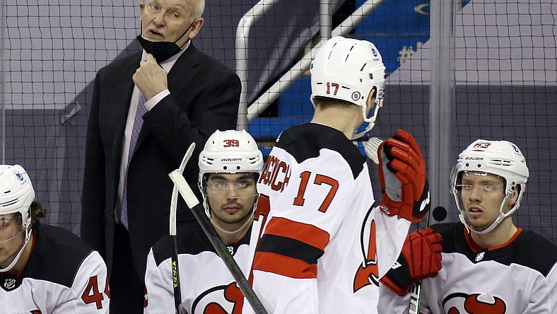 Mar 21, 2021; Pittsburgh, Pennsylvania, USA;  New Jersey Devils head coach Lindy Ruff (left) talks to center Yegor Sharangovich (17) against the Pittsburgh Penguins during the second period at PPG Paints Arena. New Jersey won 2-1 in overtime. Mandatory Credit: Charles LeClaire-USA TODAY Sports