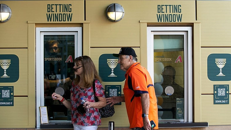 Marlys Kybartas and her husband, Ed Kybartas, walk by the Caesars Sportsbook betting window at Chase Field in Phoenix on the first day of sports betting on Sept. 9, 2021.

Caesars Sportsbook At Chase Field