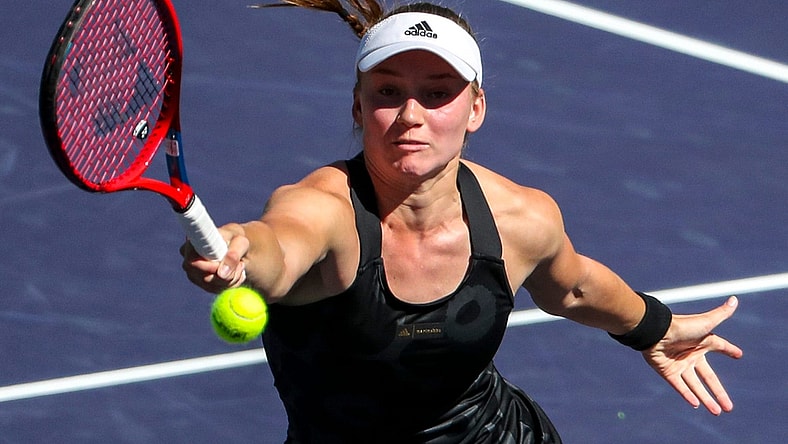 Elena Rybakina of Kazakhstan returns while playing against Su-Wei Hsieh of Taiwan and Elise Mertens of Belgium with doubles partner Veronika Kudermetova of Russia during the women's doubles final of the BNP Paribas Open at the Indian Wells Tennis Garden, Saturday, Oct. 16, 2021, in Indian Wells, Calif.