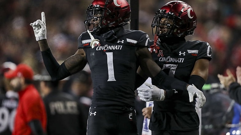 Nov 20, 2021; Cincinnati, Ohio, USA; Cincinnati Bearcats cornerback Ahmad Gardner (1) and cornerback Coby Bryant (7) react after cornerback Arquon Bush (not pictured) blocked a field goal by the Southern Methodist Mustangs in the second half at Nippert Stadium. Mandatory Credit: Katie Stratman-USA TODAY Sports