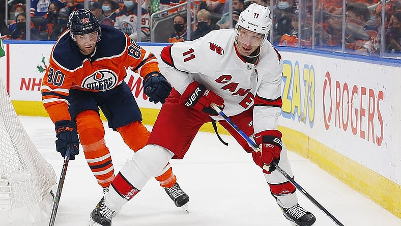 Dec 11, 2021; Edmonton, Alberta, CAN; Carolina Hurricanes forward Jordan Staal (11) looks to make a pas in front of Edmonton Oilers defensemen Markus Neimelainen (80) during the second period at Rogers Place. Mandatory Credit: Perry Nelson-USA TODAY Sports