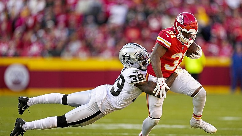 Dec 12, 2021; Kansas City, Missouri, USA; Kansas City Chiefs running back Darrel Williams (31) is tackled by Las Vegas Raiders cornerback Nate Hobbs (39) during the second half at GEHA Field at Arrowhead Stadium. Mandatory Credit: Jay Biggerstaff-USA TODAY Sports