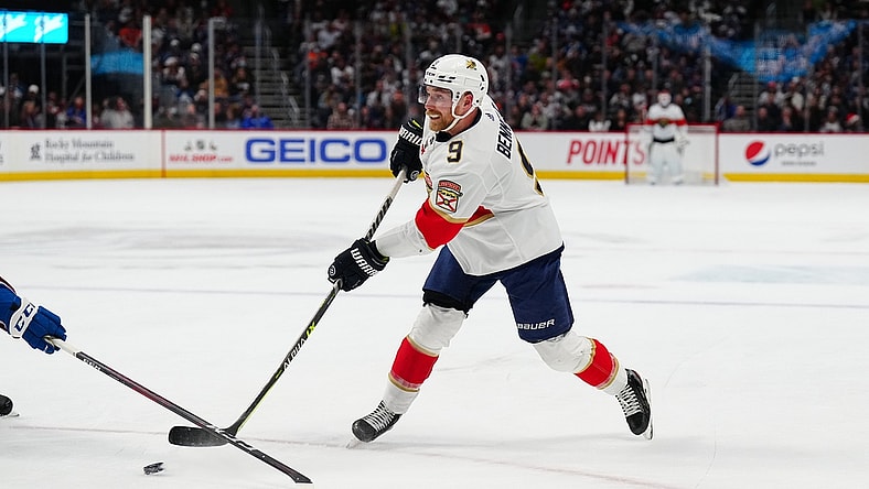 Dec 12, 2021; Denver, Colorado, USA; Florida Panthers center Sam Bennett (9) shoots the puck against the Colorado Avalanche net in the first period at Ball Arena. Mandatory Credit: Ron Chenoy-USA TODAY Sports