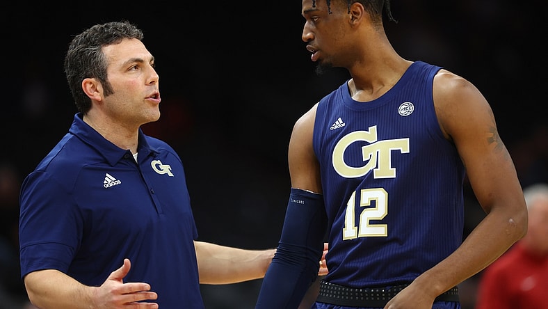 Dec 18, 2021; Phoenix, Arizona, USA; Georgia Tech Yellow Jackets head coach Josh Pastner talks to forward Khalid Moore (12) against the Southern California Trojans during the Colangelo Classic at Footprint Center. Mandatory Credit: Mark J. Rebilas-USA TODAY Sports