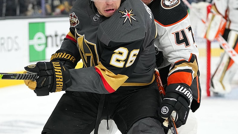 Dec 31, 2021; Las Vegas, Nevada, USA; Anaheim Ducks defenseman Hampus Lindholm (47) tips the puck away from Vegas Golden Knights center Mattias Janmark (26) during the second period at T-Mobile Arena. Mandatory Credit: Stephen R. Sylvanie-USA TODAY Sports