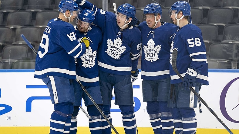 Jan 1, 2022; Toronto, Ontario, CAN; Toronto Maple Leafs right wing Ilya Mikheyev (65) celebrates scoring a goal with Toronto Maple Leafs center Jason Spezza (19) and Toronto Maple Leafs defenseman Rasmus Sandin (38) during the third period against the Ottawa Senators at Scotiabank Arena. Mandatory Credit: Nick Turchiaro-USA TODAY Sports