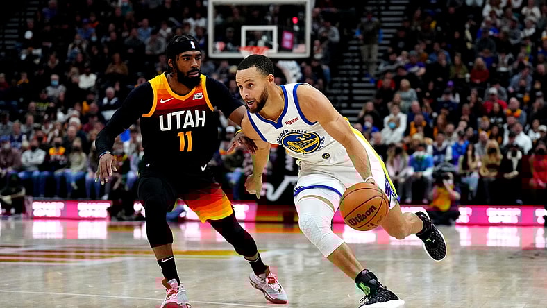 Jan 1, 2022; Salt Lake City, Utah, USA; Golden State Warriors guard Stephen Curry (30) drives past Utah Jazz guard Mike Conley (11) in the first half at Vivint Arena. Mandatory Credit: Ron Chenoy-USA TODAY Sports