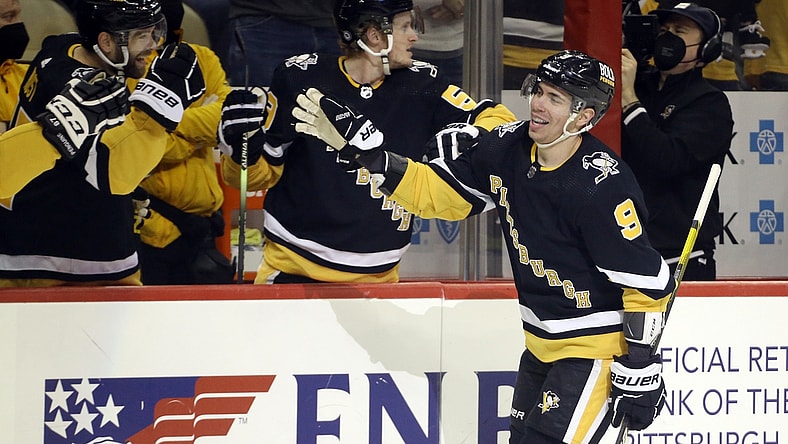 Jan 2, 2022; Pittsburgh, Pennsylvania, USA; Pittsburgh Penguins center Evan Rodrigues (9) celebrates his second goal of the game with the Pens bench against the San Jose Sharks during the first period at PPG Paints Arena. Mandatory Credit: Charles LeClaire-USA TODAY Sports