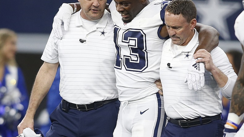 Jan 2, 2022; Arlington, Texas, USA; Dallas Cowboys wide receiver Michael Gallup (13) is helped off the field after an injury in the second quarter against the Arizona Cardinals at AT&T Stadium. Mandatory Credit: Tim Heitman-USA TODAY Sports