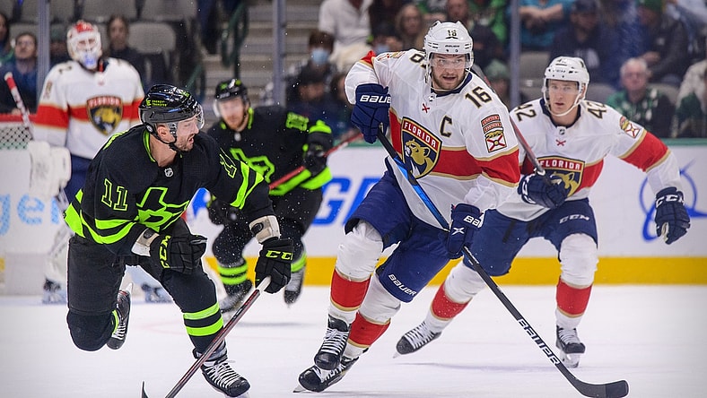 Jan 6, 2022; Dallas, Texas, USA; Dallas Stars center Luke Glendening (11) and Florida Panthers center Aleksander Barkov (16) chase the puck during the first period at the American Airlines Center. Mandatory Credit: Jerome Miron-USA TODAY Sports