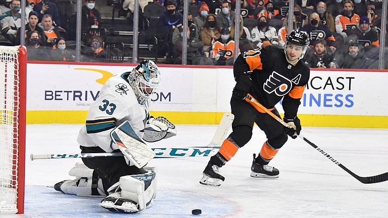 Jan 8, 2022; Philadelphia, Pennsylvania, USA; San Jose Sharks goaltender Adin Hill (33) makes a save as Philadelphia Flyers center Scott Laughton (21) looks on during the second period at Wells Fargo Center. Mandatory Credit: Eric Hartline-USA TODAY Sports