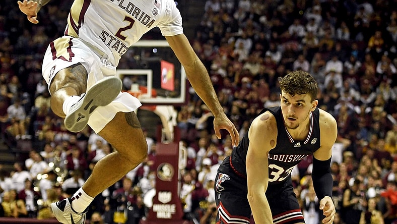 Jan 8, 2022; Tallahassee, Florida, USA; Louisville Cardinals forward Matt Cross (33) passes the ball against Florida State Seminoles guard Anthony Polite (2) during the first half at Donald L. Tucker Center. Mandatory Credit: Melina Myers-USA TODAY Sports