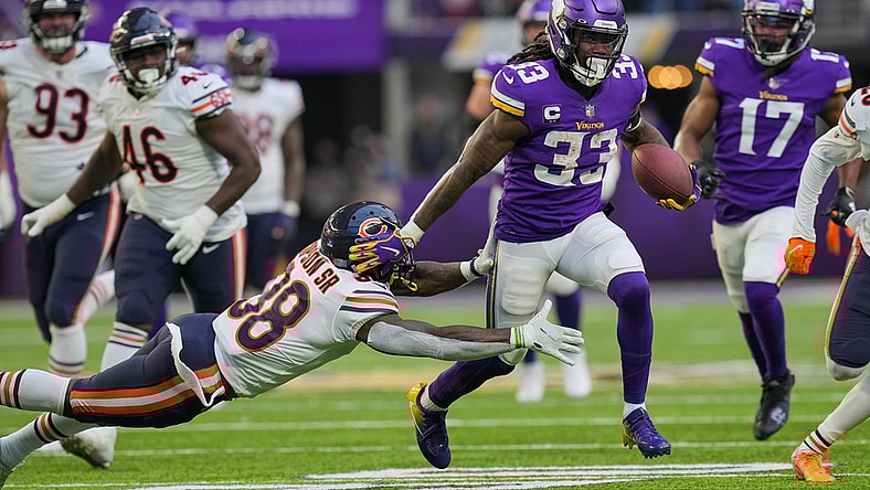 Jan 9, 2022; Minneapolis, Minnesota, USA; Minnesota Vikings running back Dalvin Cook (33) runs with the ball against the Chicago Bears safety Tashaun Gipson (38) in the fourth quarter at U.S. Bank Stadium. Mandatory Credit: Brad Rempel-USA TODAY Sports