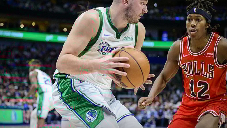 Jan 9, 2022; Dallas, Texas, USA; Dallas Mavericks guard Luka Doncic (77) grabs a rebound in front of Chicago Bulls guard Ayo Dosunmu (12) during the second quarter at the American Airlines Center. Mandatory Credit: Jerome Miron-USA TODAY Sports