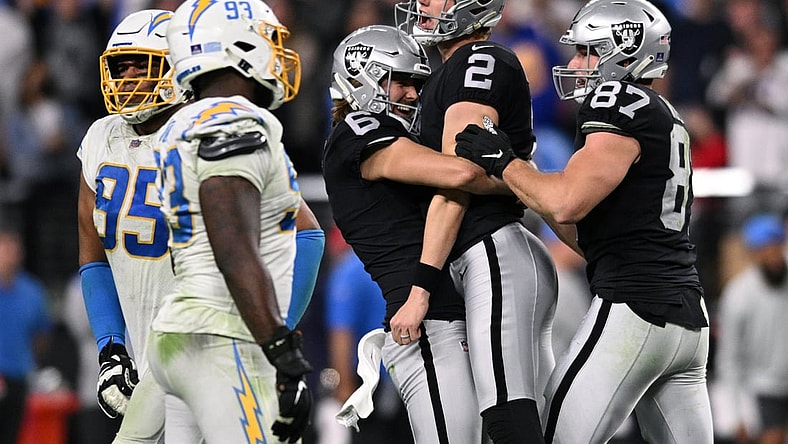 Jan 9, 2022; Paradise, Nevada, USA; Las Vegas Raiders kicker Daniel Carlson (2) celebrates with punter A.J. Cole (6) and tight end Foster Moreau (87) after kicking a game-winning field goal in overtime against the Los Angeles Chargers at Allegiant Stadium. Mandatory Credit: Orlando Ramirez-USA TODAY Sports