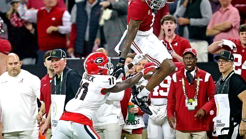 Jan 10, 2022; Indianapolis, IN, USA; Alabama Crimson Tide wide receiver Jameson Williams (1) tries to jumps over Georgia Bulldogs defensive back Derion Kendrick (11) during the first quarter in the 2022 CFP college football national championship game at Lucas Oil Stadium. Mandatory Credit: Mark J. Rebilas-USA TODAY Sports