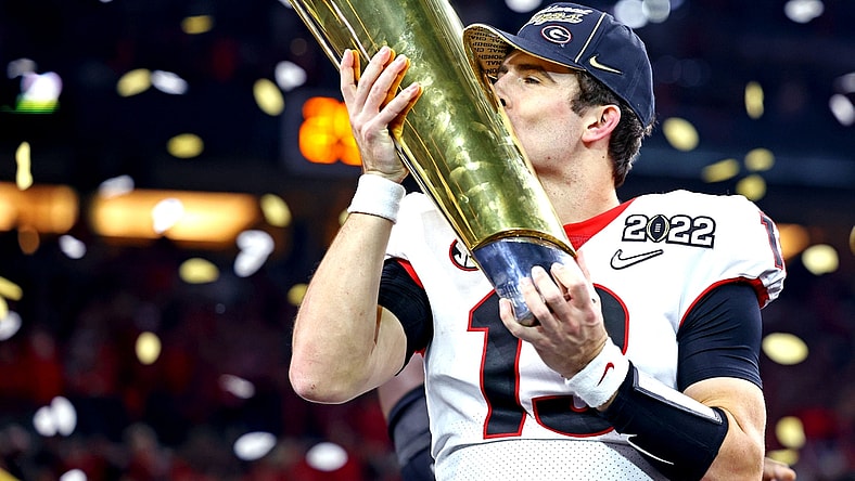 Jan 10, 2022; Indianapolis, IN, USA; Georgia Bulldogs quarterback Stetson Bennett (13) celebrates after the Georgia Bulldogs beat the Alabama Crimson Tide in the 2022 CFP college football national championship game at Lucas Oil Stadium. Mandatory Credit: Mark J. Rebilas-USA TODAY Sports