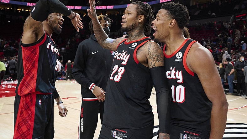 Jan 10, 2022; Portland, Oregon, USA; Portland Trail Blazers forward Robert Covington (33) celebrates with guard Ben McLemore (23) and guard Dennis Smith Jr. (10) after a game against the Brooklyn Nets at Moda Center. The Trail Blazers won the game 114-108. Mandatory Credit: Troy Wayrynen-USA TODAY Sports