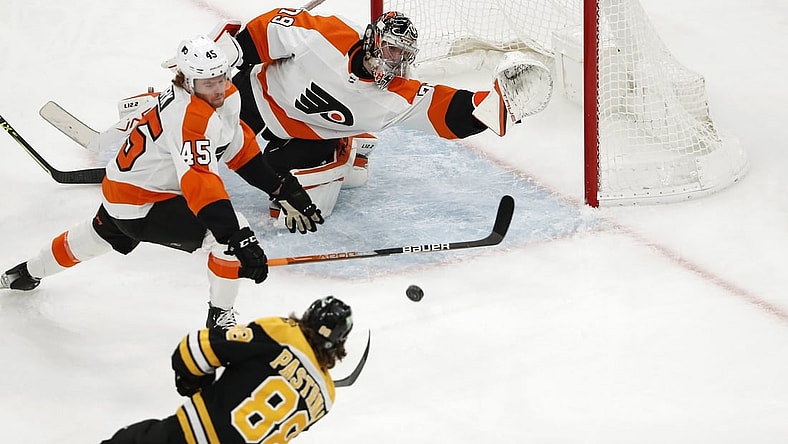 Jan 13, 2022; Boston, Massachusetts, USA; Boston Bruins right wing David Pastrnak (88) scores a goal past Philadelphia Flyers goaltender Carter Hart (79) and defenseman Cam York (45) during the first period at TD Garden. Mandatory Credit: Winslow Townson-USA TODAY Sports