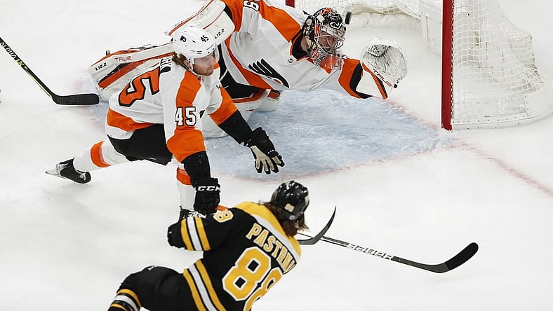 Jan 13, 2022; Boston, Massachusetts, USA; Boston Bruins right wing David Pastrnak (88) scores a goal past Philadelphia Flyers goaltender Carter Hart (79) and defenseman Cam York (45) during the first period at TD Garden. Mandatory Credit: Winslow Townson-USA TODAY Sports