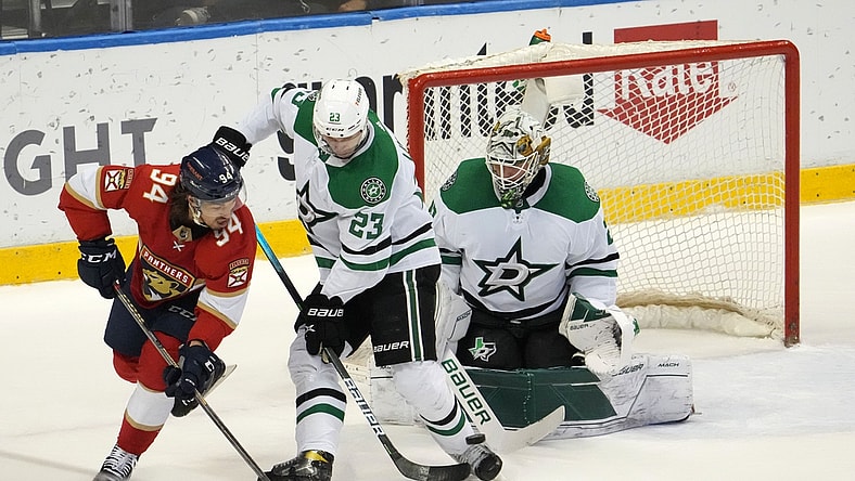 Jan 14, 2022; Sunrise, Florida, USA; Florida Panthers left wing Ryan Lomberg (94) attempts to redirect the puck in front of Dallas Stars defenseman Esa Lindell (23) and goaltender Jake Oettinger (29) during the first period at FLA Live Arena. Mandatory Credit: Jasen Vinlove-USA TODAY Sports