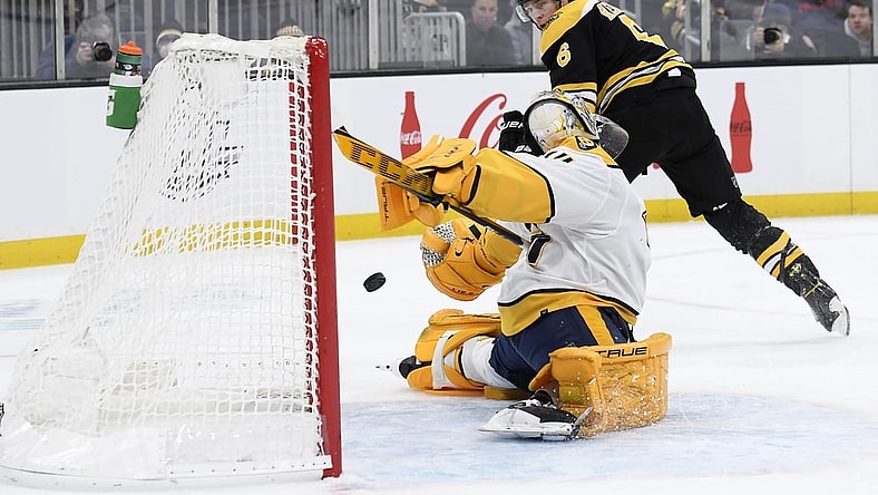 Jan 15, 2022; Boston, Massachusetts, USA;  Boston Bruins defenseman Mike Reilly (6) scores a goal past Nashville Predators goaltender Juuse Saros (74) during the first period at TD Garden. Mandatory Credit: Bob DeChiara-USA TODAY Sports