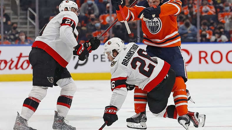 Jan 15, 2022; Edmonton, Alberta, CAN; Edmonton Oilers forward Zach Hyman (18) checks Ottawa Senators defensemen Erik Brannstrom (26) during the third period at Rogers Place. Mandatory Credit: Perry Nelson-USA TODAY Sports