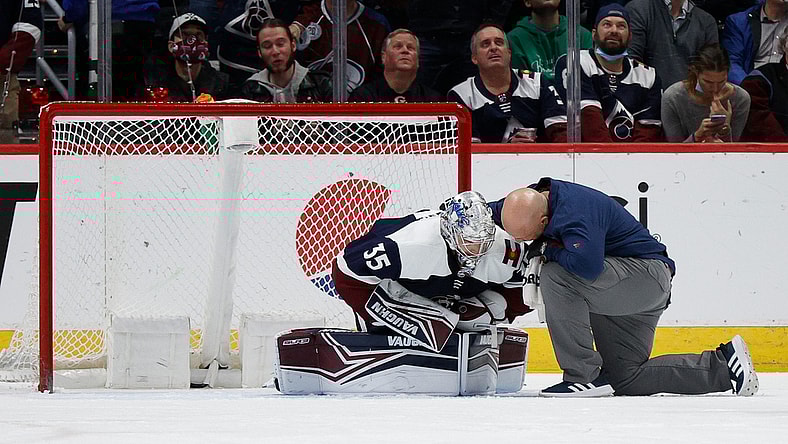 Jan 17, 2022; Denver, Colorado, USA; Colorado Avalanche goaltender Darcy Kuemper (35) is tended to by head athletic trainer Matt Sokolowski after a play in the second period against the Minnesota Wild at Ball Arena. Mandatory Credit: Isaiah J. Downing-USA TODAY Sports