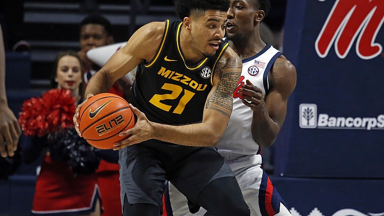 Jan 18, 2022; Oxford, Mississippi, USA; Missouri Tigers forward Ronnie DeGray III (21) spins toward the basket as Mississippi Rebels guard Tye Fagan (14) defends during the first half at The Sandy and John Black Pavilion at Ole Miss. Mandatory Credit: Petre Thomas-USA TODAY Sports