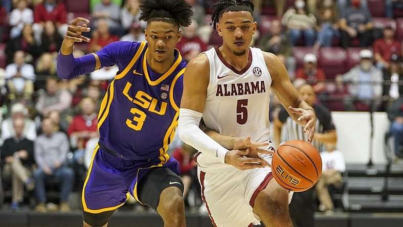 Jan 19, 2022; Tuscaloosa, Alabama, USA; LSU Tigers forward Alex Fudge (3) reaches for the ball from Alabama Crimson Tide guard Jaden Shackelford (5) during the second half at Coleman Coliseum. Mandatory Credit: Marvin Gentry-USA TODAY Sports
