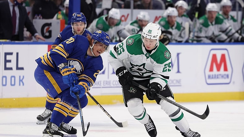 Jan 20, 2022; Buffalo, New York, USA; Dallas Stars left wing Joel Kiviranta (25) watches as Buffalo Sabres center Cody Eakin (20) looks to control the puck during the first period at KeyBank Center. Mandatory Credit: Timothy T. Ludwig-USA TODAY Sports