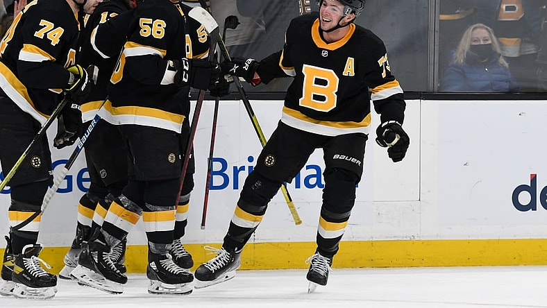 Jan 20, 2022; Boston, Massachusetts, USA; Boston Bruins defenseman Charlie McAvoy (73) celebrates with his teammates after scoring against the Washington Capitals during the third period at the TD Garden. Mandatory Credit: Brian Fluharty-USA TODAY Sports