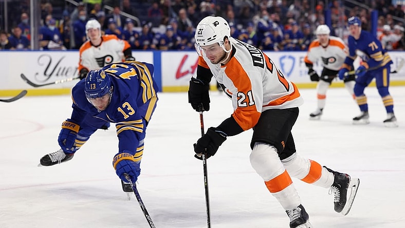 Jan 22, 2022; Buffalo, New York, USA;  Buffalo Sabres defenseman Mark Pysyk (13) tries to block a shot by Philadelphia Flyers center Scott Laughton (21) during the first period at KeyBank Center. Mandatory Credit: Timothy T. Ludwig-USA TODAY Sports