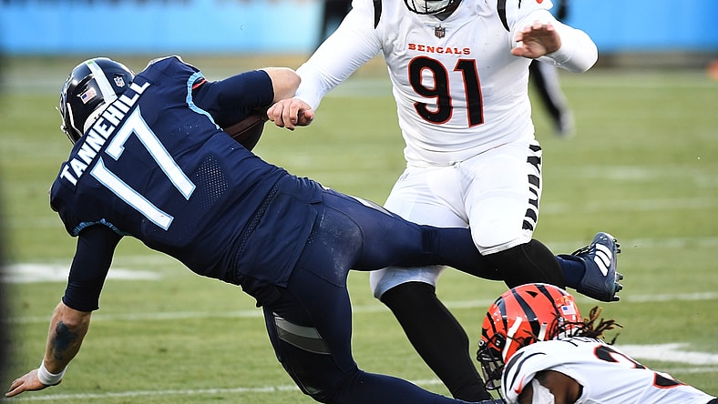 Jan 22, 2022; Nashville, Tennessee, USA; Tennessee Titans quarterback Ryan Tannehill (17) is tackled by Cincinnati Bengals defensive end Trey Hendrickson (91) during the first half of an AFC Divisional playoff football game at Nissan Stadium. Mandatory Credit: Christopher Hanewinckel-USA TODAY Sports