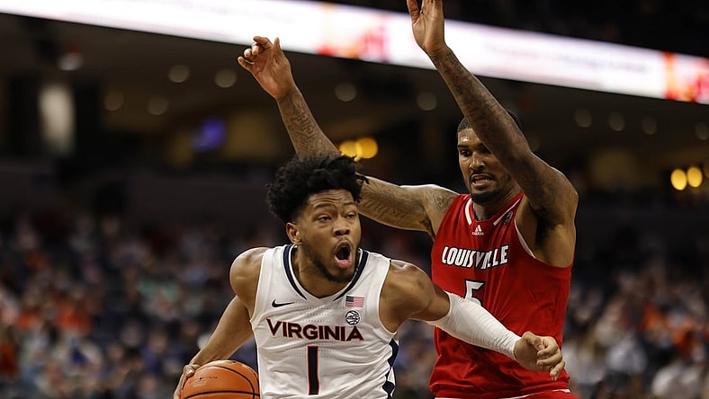 Jan 24, 2022; Charlottesville, Virginia, USA; Virginia Cavaliers forward Jayden Gardner (1) drives to the basket as Louisville Cardinals forward Malik Williams (5) defends during the second half at John Paul Jones Arena. Mandatory Credit: Geoff Burke-USA TODAY Sports