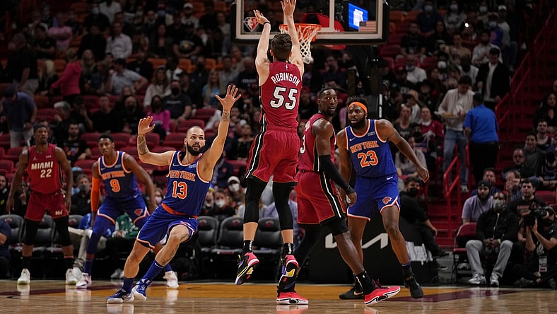 Jan 26, 2022; Miami, Florida, USA; Miami Heat guard Duncan Robinson (55) attempts a three point shot over New York Knicks guard Evan Fournier (13) during the first half at FTX Arena. Mandatory Credit: Jasen Vinlove-USA TODAY Sports
